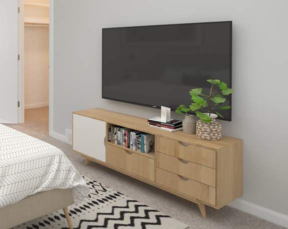 A modern living room with a flat screen TV on a wooden stand. at 7 Pointe Apartments, Indianapolis, Indiana