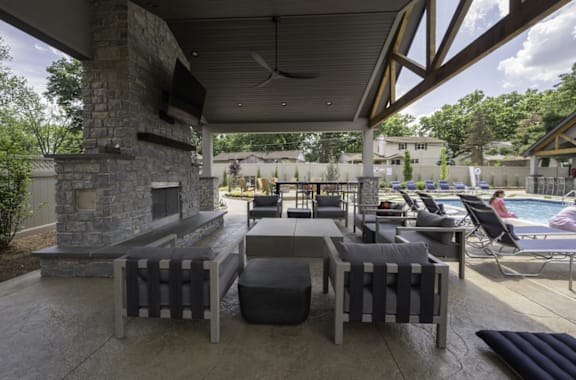 a patio with a fireplace and lounge chairs at Olde Towne in Kenwood, Ohio