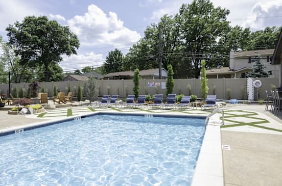 a swimming pool with lounge chairs and trees in the background at Olde Towne in Kenwood, Ohio, 45243