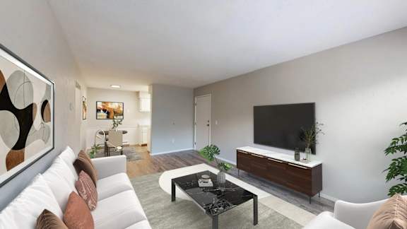 A modern living room with a white sofa, a black coffee table, and a large painting on the wall.