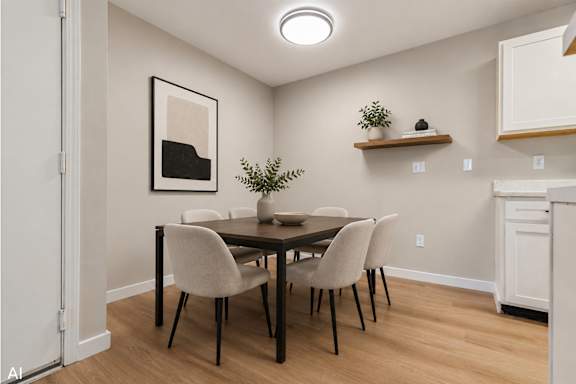 A dining room with a table and chairs.