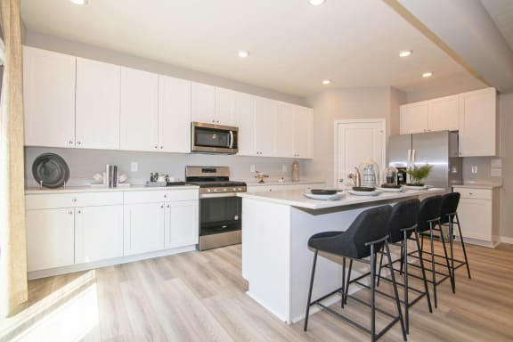 a kitchen with white cabinets and a counter top at Jackson Run Townhomes, Whitestown, IN