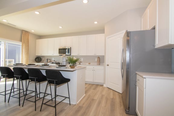 a kitchen with a counter top and a refrigerator at Jackson Run Townhomes, Whitestown Indiana