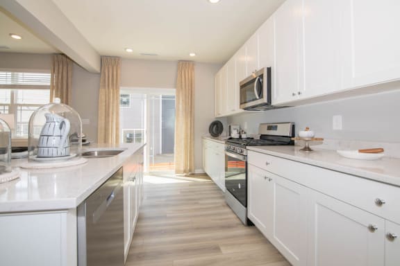 a kitchen with white cabinets and a counter top at Jackson Run Townhomes, Whitestown, 46075