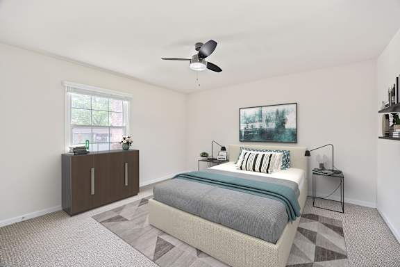 A bedroom with a bed, nightstands, and a ceiling fan.