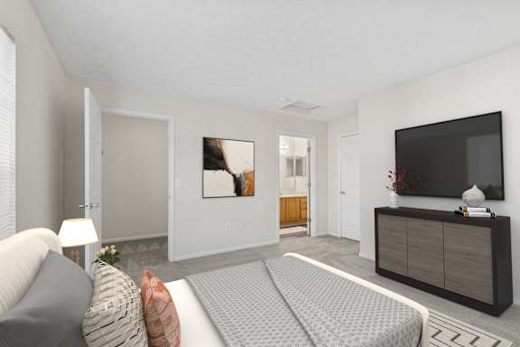 A modern living room with a grey sofa and a grey patterned bedspread.