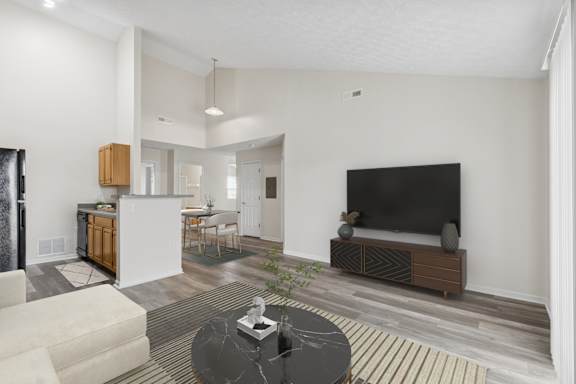 A modern living room with a black sofa and a television.