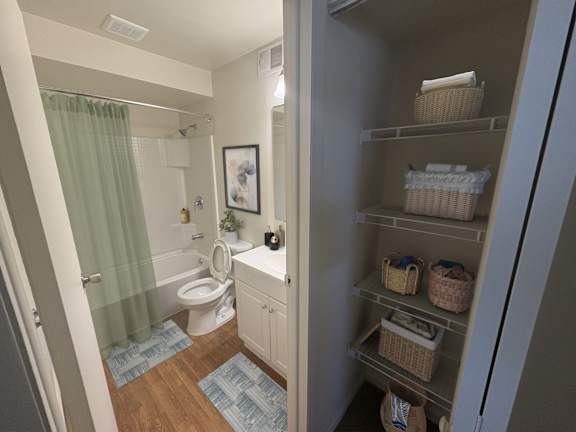 A bathroom with a toilet, sink, and shower.