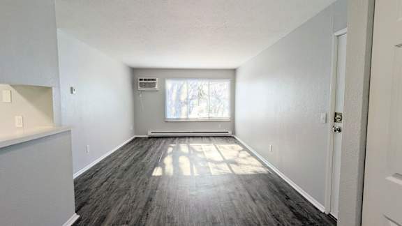 A room with a window and a door.