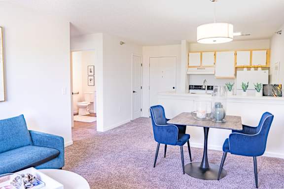 A dining room with a table and chairs.