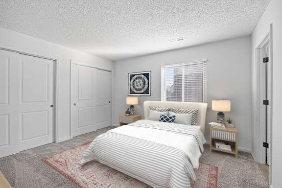 A bedroom with a large bed and two nightstands.
