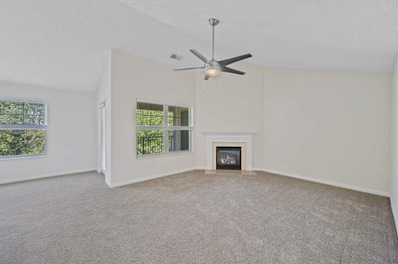 A room with a fireplace and a ceiling fan.