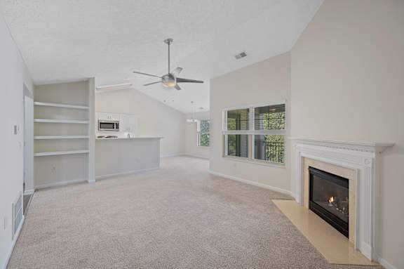 A living room with a fireplace and a ceiling fan.