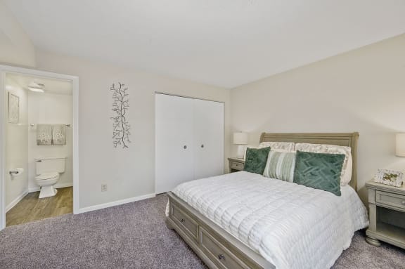 a bedroom with a bed and a bathroom with a toilet