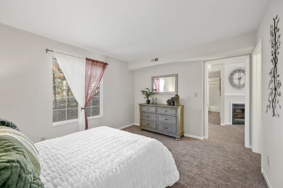 a bedroom with a bed and a dresser in it
