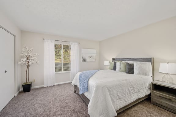 a bedroom with a large bed and a window