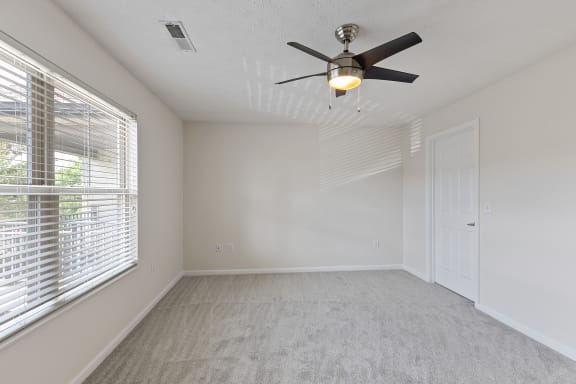 an empty bedroom with a ceiling fan and a window at Four Bridges, Liberty Township, 45044-8380