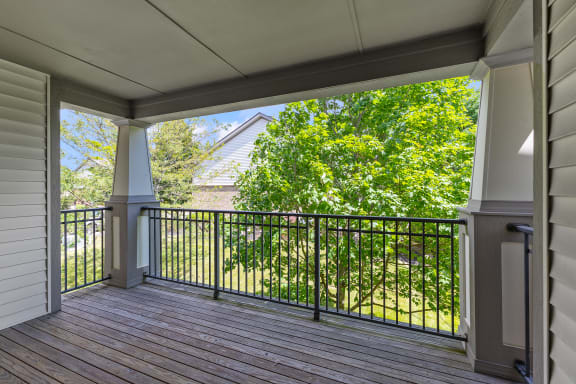 a covered porch with a view of a yard and trees at Four Bridges, Liberty Township, 45044-8380