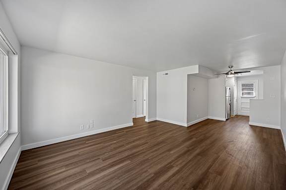 A room with wooden floors and white walls.