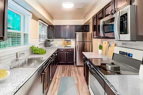 a kitchen with stainless steel appliances and marble counter tops at Olde Towne in Kenwood, Ohio, 45243
