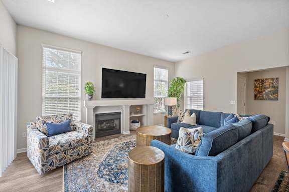 A living room with a blue couch and a television.