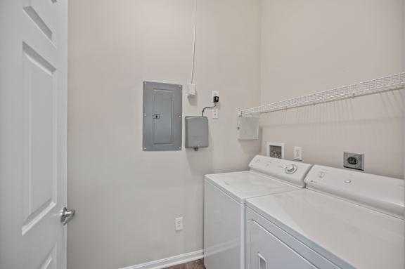 A white washer and dryer in a laundry room.