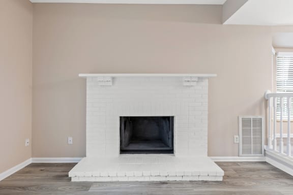 a white brick fireplace with a white mantel