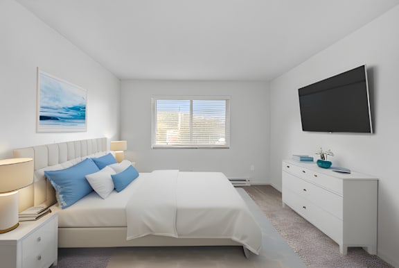 A bedroom with a white bed, nightstand, and a painting on the wall.