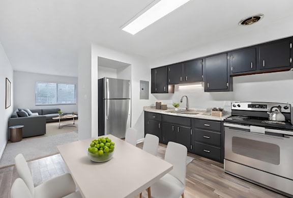 A modern kitchen with a dining table and chairs.
