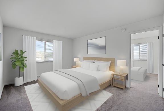 A bedroom with a large bed, a nightstand, and a plant.
