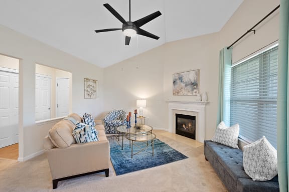 Living room with a couch and a chair and a fireplace at Four Bridges, Liberty Township, OH