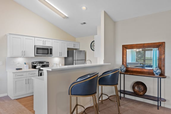 Kitchen with a bar with two chairs and a sink at Four Bridges, Ohio