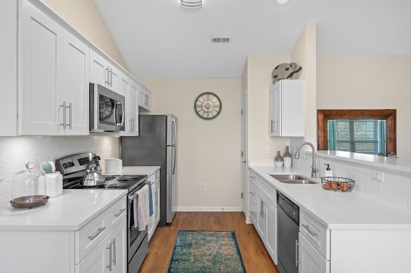 Kitchen with white cabinets and stainless steel appliances at Four Bridges, Liberty Township, 45044-8380