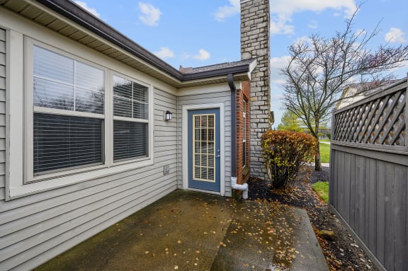 Front of a house with a blue door at Four Bridges, Liberty Township, OH