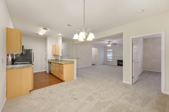 Empty living room and kitchen with an open floor plan at Four Bridges, Liberty Township, Ohio