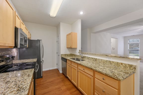 Kitchen with granite counter tops and stainless steel appliances at Four Bridges, Liberty Township, OH, 45044-8380