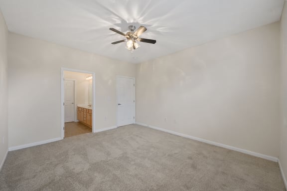 Empty living room with a ceiling fan and carpet at Four Bridges, Liberty Township, OH, 45044-8380