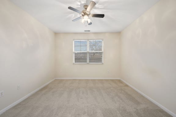 Empty room with a ceiling fan and a window at Four Bridges, Liberty Township, OH