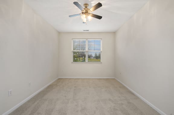 Empty room with a ceiling fan and a window at Four Bridges, Liberty Township, Ohio