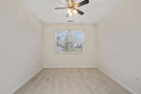 Empty bedroom with a ceiling fan and a window at Four Bridges, Liberty Township, 45044-8380