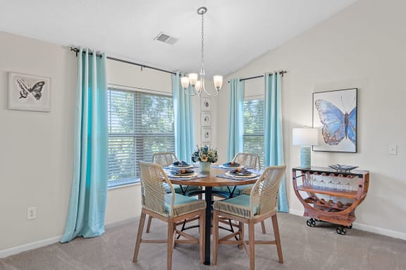 Dining room with a table and chairs and a chandelier at Four Bridges, Liberty Township, Ohio