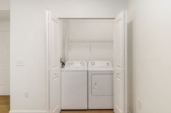 a washer and dryer in a room with white walls