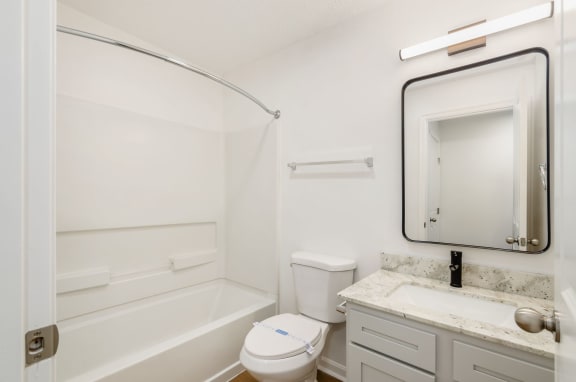 a bathroom with a sink toilet and a bath tub