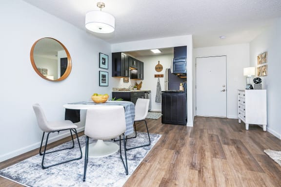 a living room with a dining room table and chairs and a kitchen
