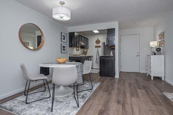 A dining room with a white table and chairs.