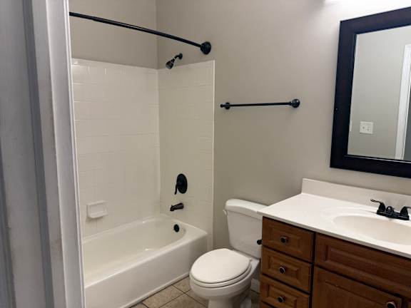 A white toilet sits next to a white sink in a bathroom.