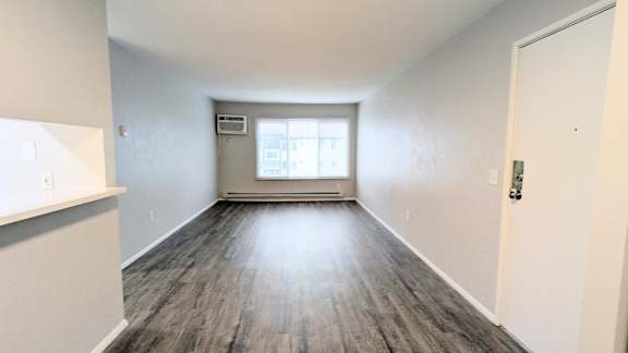 A room with a window and a door.