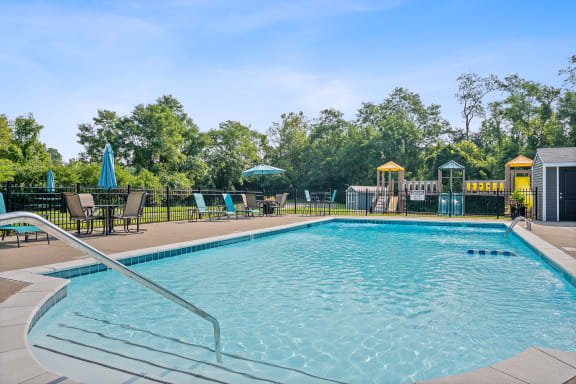 Resort style swimming pool is open to the community and is surrounded by deck chairs at Galbraith Pointe Apartments and Townhomes, Cincinnati
