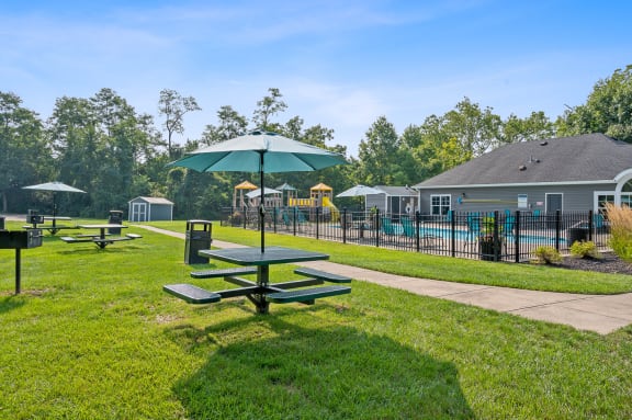 Picnic area with tables and umbrellas at Galbraith Pointe Apartments and Townhomes, Cincinnati, OH