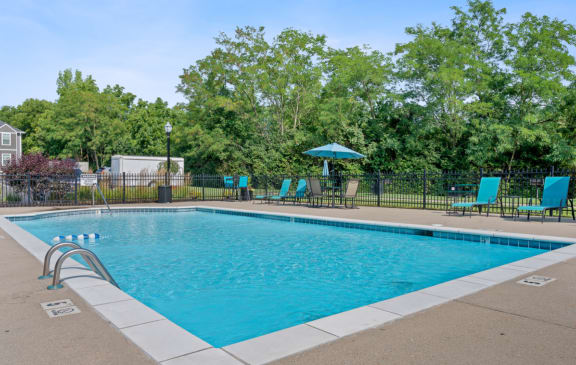 Swimming pool with blue chairs and a fence around it at Galbraith Pointe Apartments and Townhomes*, Ohio, 45231